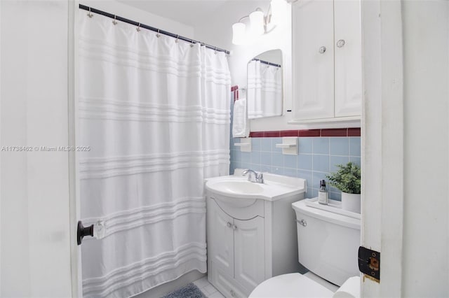 bathroom with tile walls, vanity, toilet, and a shower with shower curtain