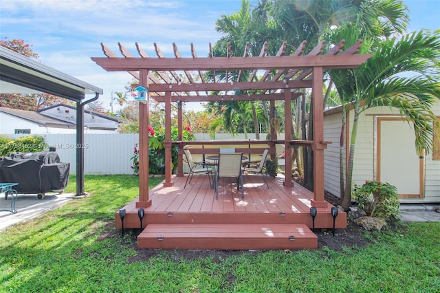 wooden terrace with a yard and a pergola