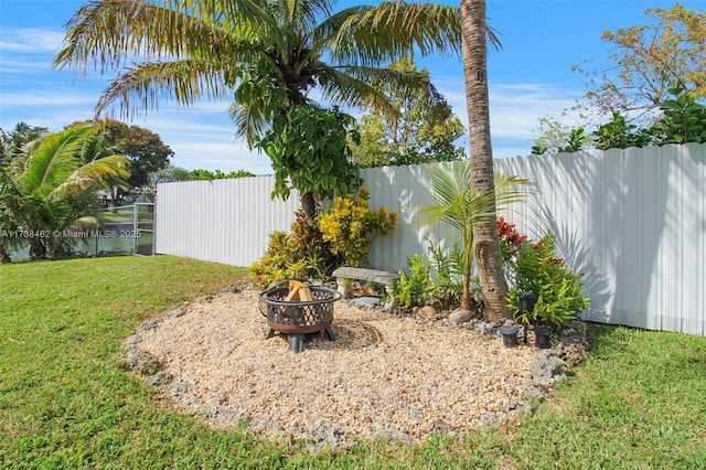 view of yard with an outdoor fire pit