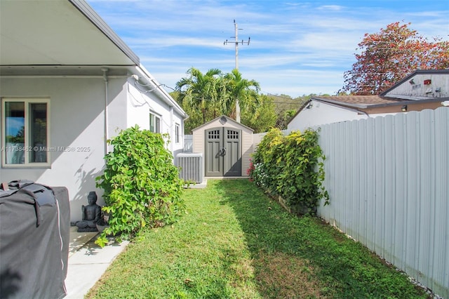 view of yard with a storage unit and central AC unit