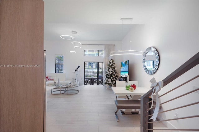 interior space featuring light hardwood / wood-style floors and a high ceiling