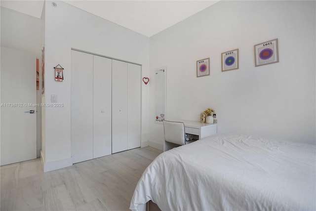 bedroom featuring a closet and light wood-type flooring