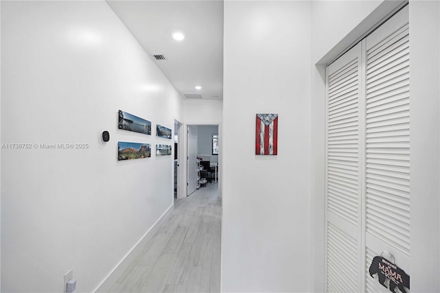 corridor with light hardwood / wood-style flooring