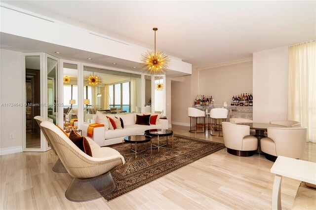 living room with a chandelier and light wood-type flooring