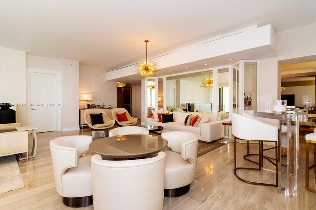 living room with a chandelier and light wood-type flooring