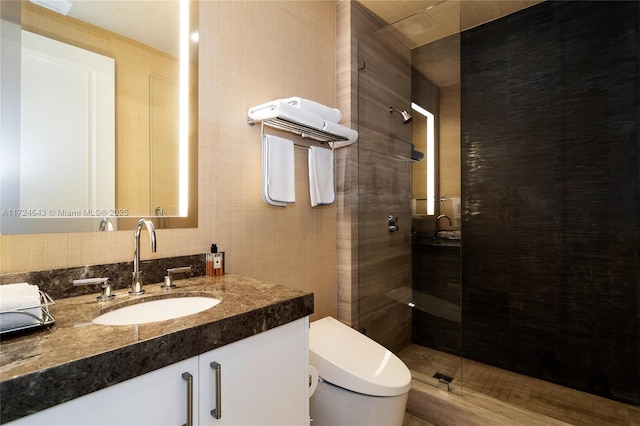 bathroom with vanity, a shower with shower door, and toilet