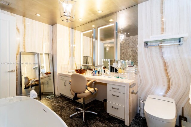 bathroom with vanity, toilet, and a bath