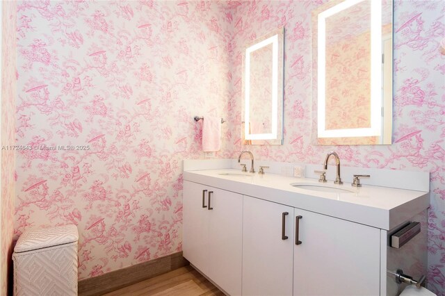 bathroom with vanity and hardwood / wood-style flooring