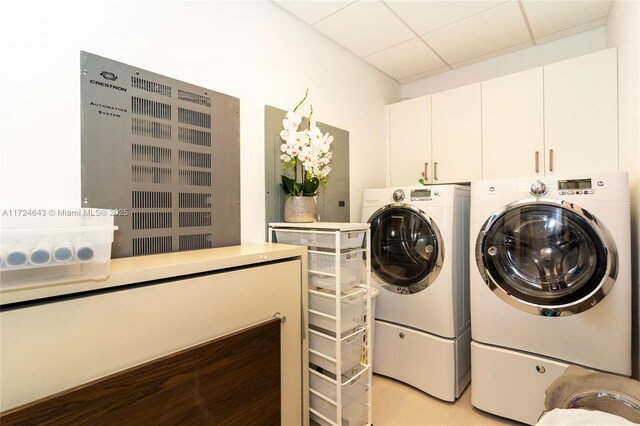 laundry room featuring cabinets and washing machine and clothes dryer