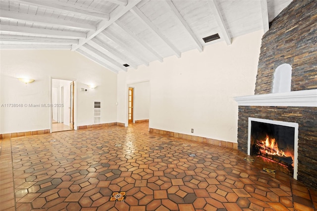 unfurnished living room with baseboards, visible vents, high vaulted ceiling, a fireplace, and beamed ceiling