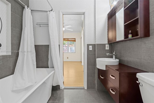 unfurnished bedroom featuring multiple closets, ceiling fan, crown molding, and light wood-type flooring