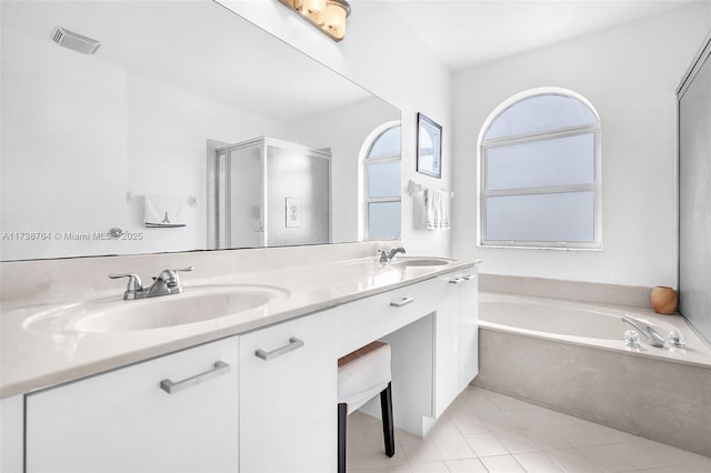 bathroom with independent shower and bath, vanity, and tile patterned flooring