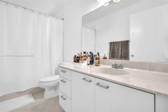 bathroom with tile patterned flooring, vanity, and toilet