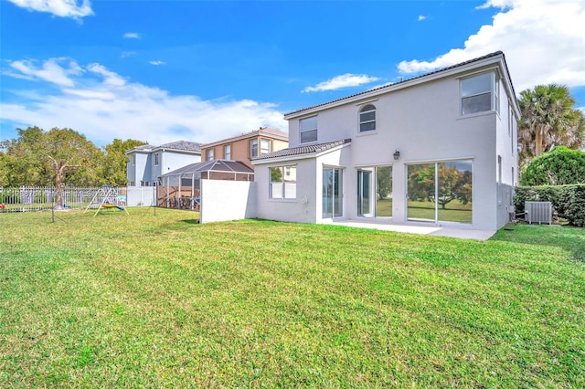 rear view of property with a yard and central air condition unit