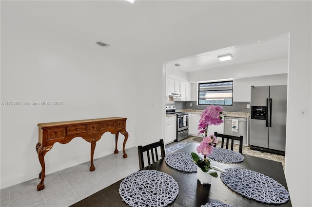 dining area with light tile patterned floors