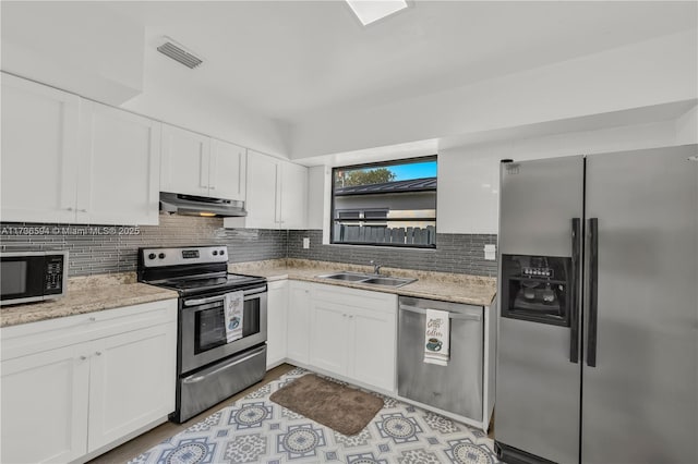 kitchen with stainless steel appliances and white cabinets