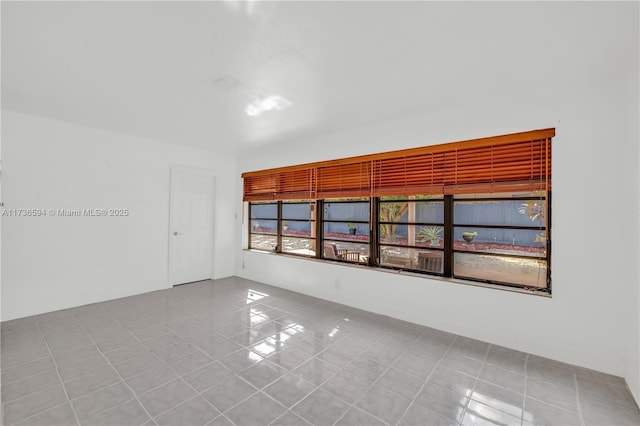 spare room featuring light tile patterned floors