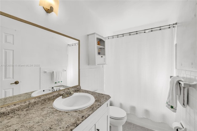 full bathroom featuring vanity, shower / bath combination with curtain, tile patterned floors, and toilet