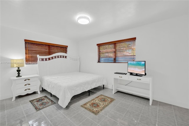 bedroom with light tile patterned floors