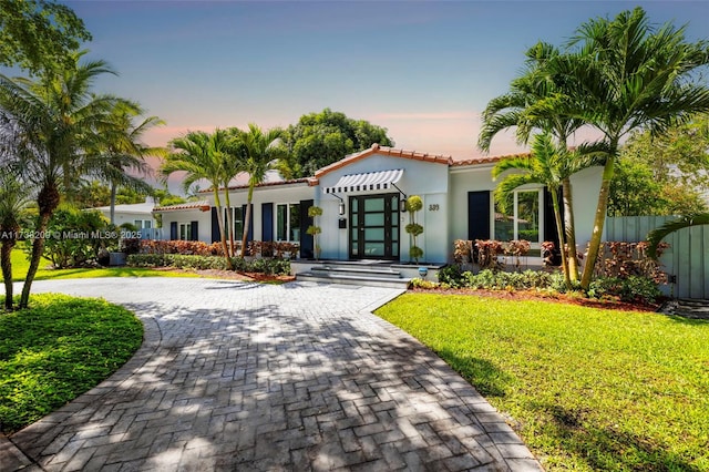 339 NE 100th St, Miami Shores, FL 33138 - mediterranean / spanish-style home with a tiled roof, stucco siding, and curved driveway
