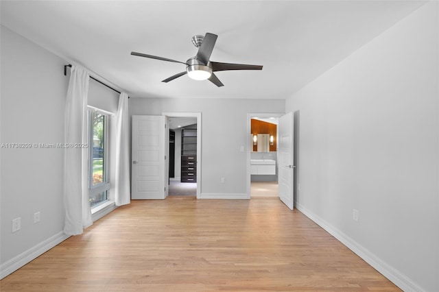 339 NE 100th St, Miami Shores, FL 33138 - unfurnished bedroom featuring light wood finished floors, baseboards, connected bathroom, and a ceiling fan
