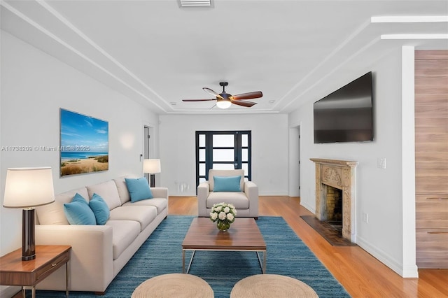 339 NE 100th St, Miami Shores, FL 33138 - living room featuring a ceiling fan, light wood-style floors, a fireplace, and baseboards