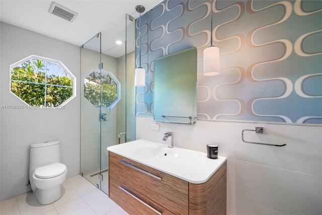 339 NE 100th St, Miami Shores, FL 33138 - bathroom featuring a shower stall, toilet, vanity, and tile patterned floors