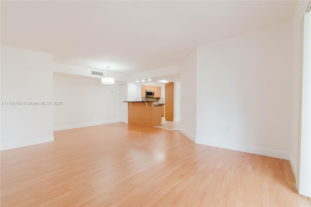 spare room featuring light hardwood / wood-style floors