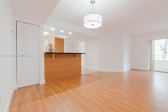 unfurnished living room with light wood-type flooring