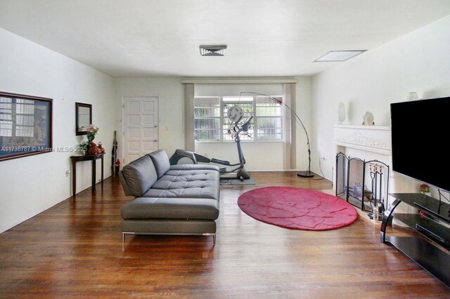 living room featuring dark hardwood / wood-style floors and a notable chandelier