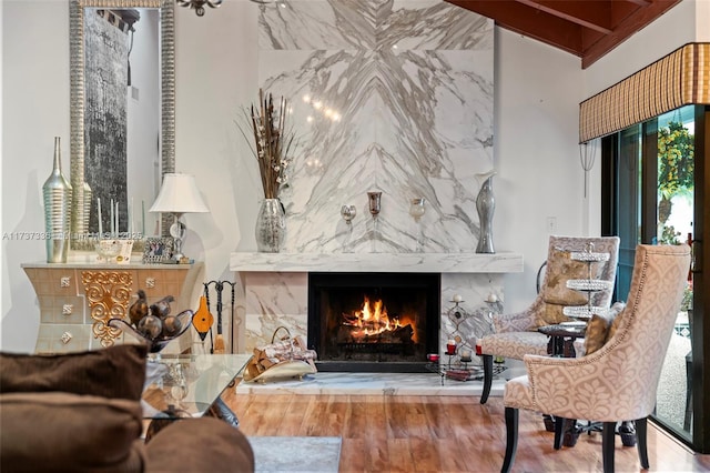 living area featuring a high end fireplace and wood-type flooring