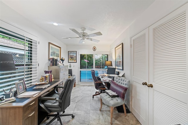 office featuring a textured ceiling and ceiling fan