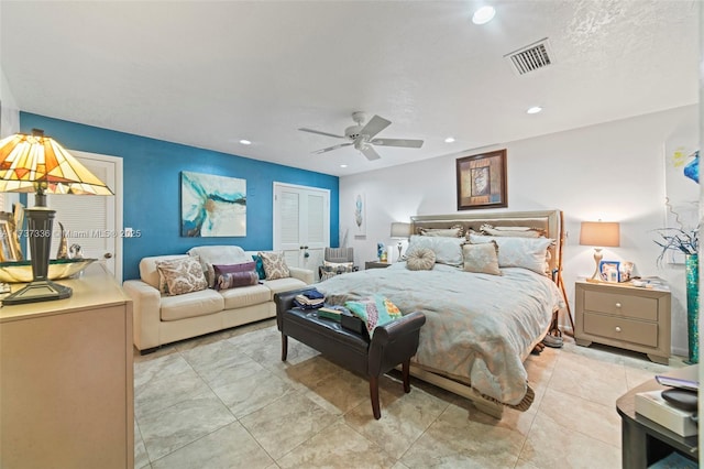 tiled bedroom with ceiling fan and a closet