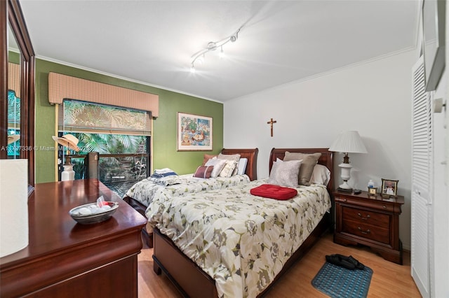 bedroom featuring hardwood / wood-style floors and crown molding