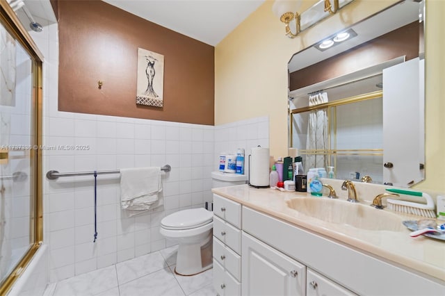 full bathroom with enclosed tub / shower combo, tile walls, tile patterned flooring, vanity, and toilet