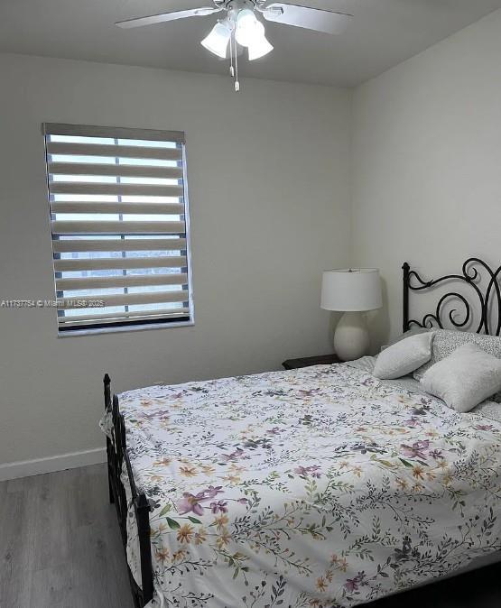 10519 W 33rd Ct Unit 10519, Hialeah, FL 33018 - bedroom with wood finished floors, baseboards, and a ceiling fan