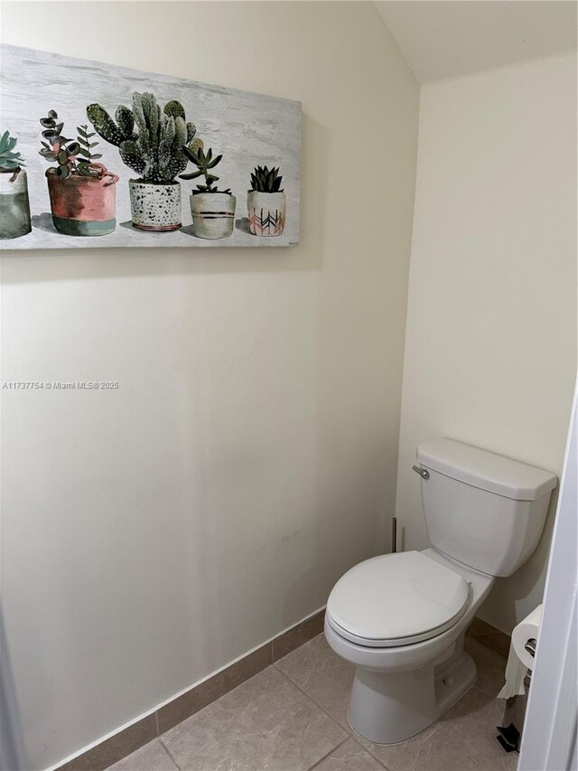 10519 W 33rd Ct Unit 10519, Hialeah, FL 33018 - bathroom featuring toilet, baseboards, and tile patterned flooring