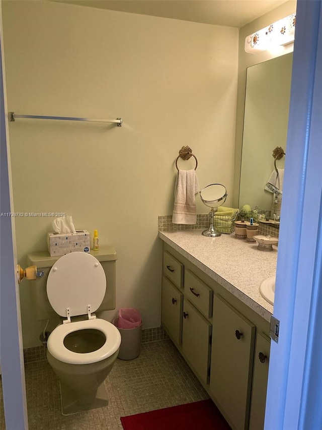 bathroom with vanity, tile patterned flooring, and toilet