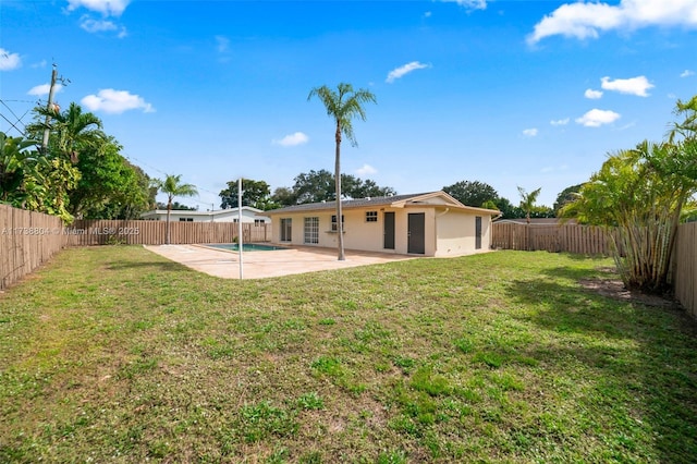 back of property featuring a yard and a patio