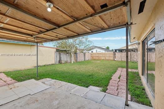 view of yard with a fenced backyard and a patio