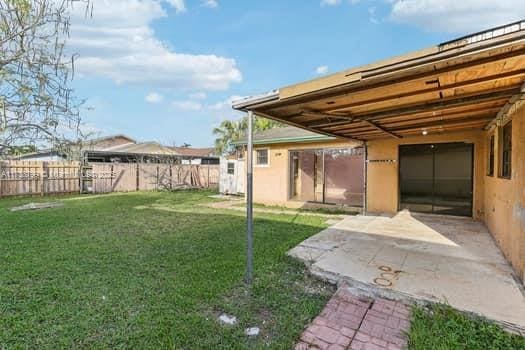 view of yard featuring a patio and fence