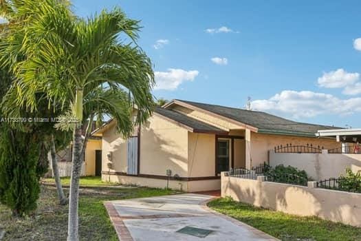 view of front of property with fence and stucco siding