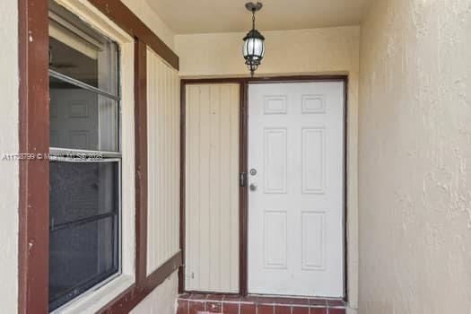 property entrance featuring stucco siding