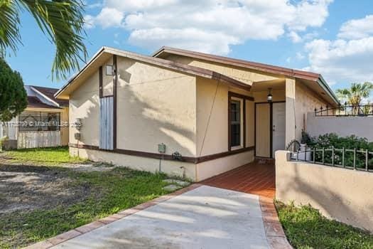 exterior space featuring fence and stucco siding