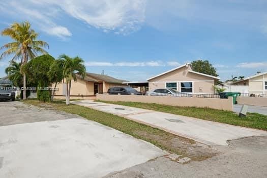 exterior space with concrete driveway and fence