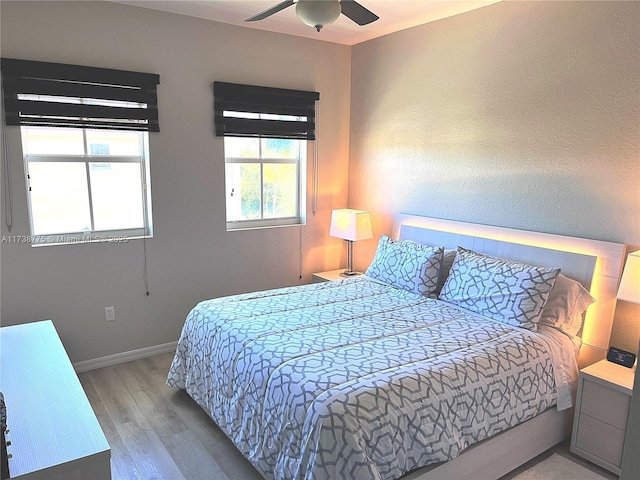 bedroom with ceiling fan and light hardwood / wood-style floors