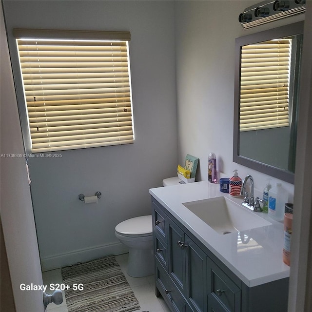 bathroom featuring vanity, tile patterned floors, and toilet