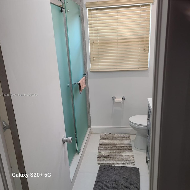 bathroom featuring tile patterned flooring, vanity, and toilet