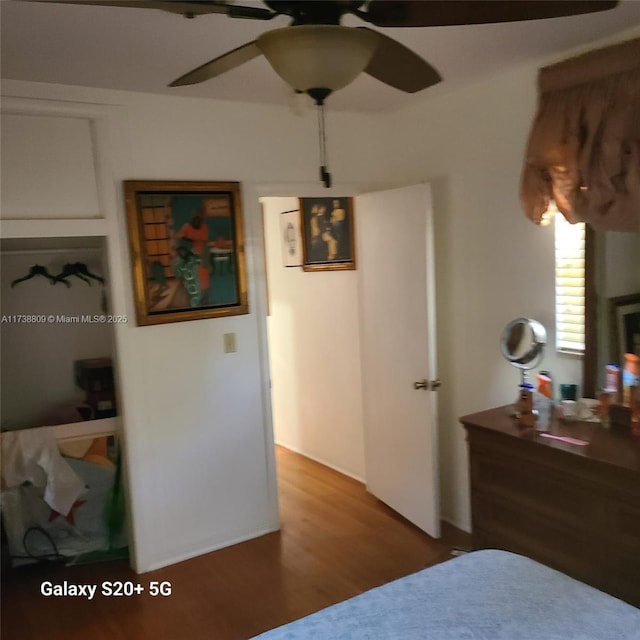 bedroom with dark wood-type flooring and ceiling fan