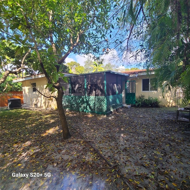 back of house featuring a sunroom